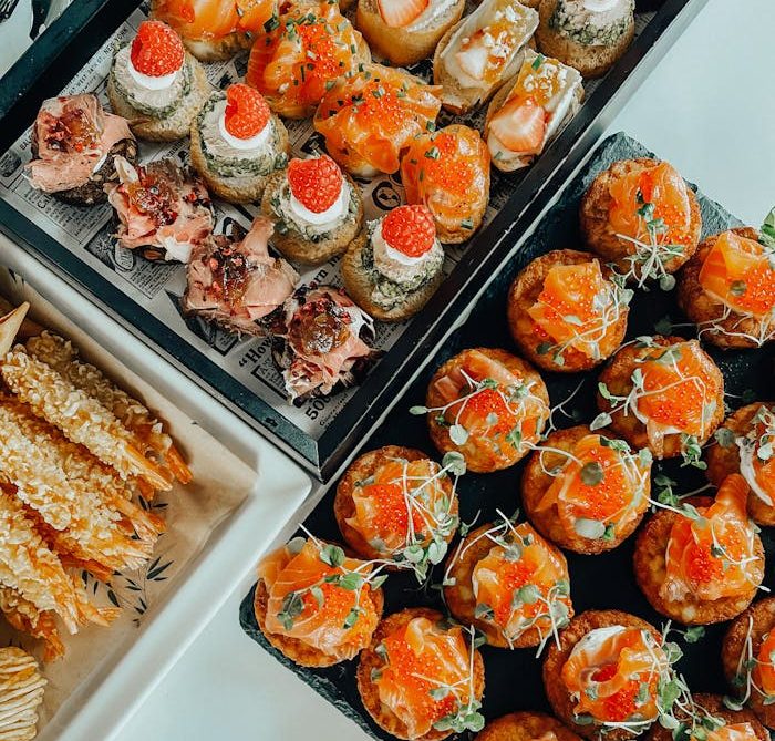 Indulge in a delicious spread of gourmet appetizers featuring seafood and savory bites, perfect for elegant dining.