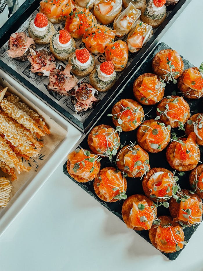 Indulge in a delicious spread of gourmet appetizers featuring seafood and savory bites, perfect for elegant dining.