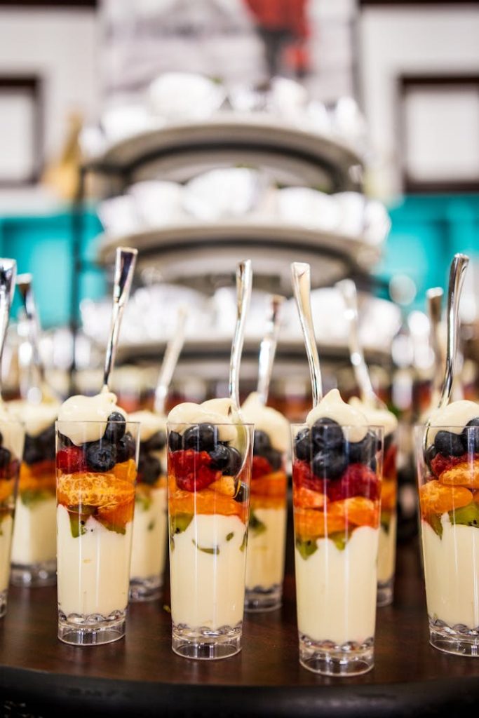 Layered fruit parfaits with yogurt and fresh berries served in elegant glasses.